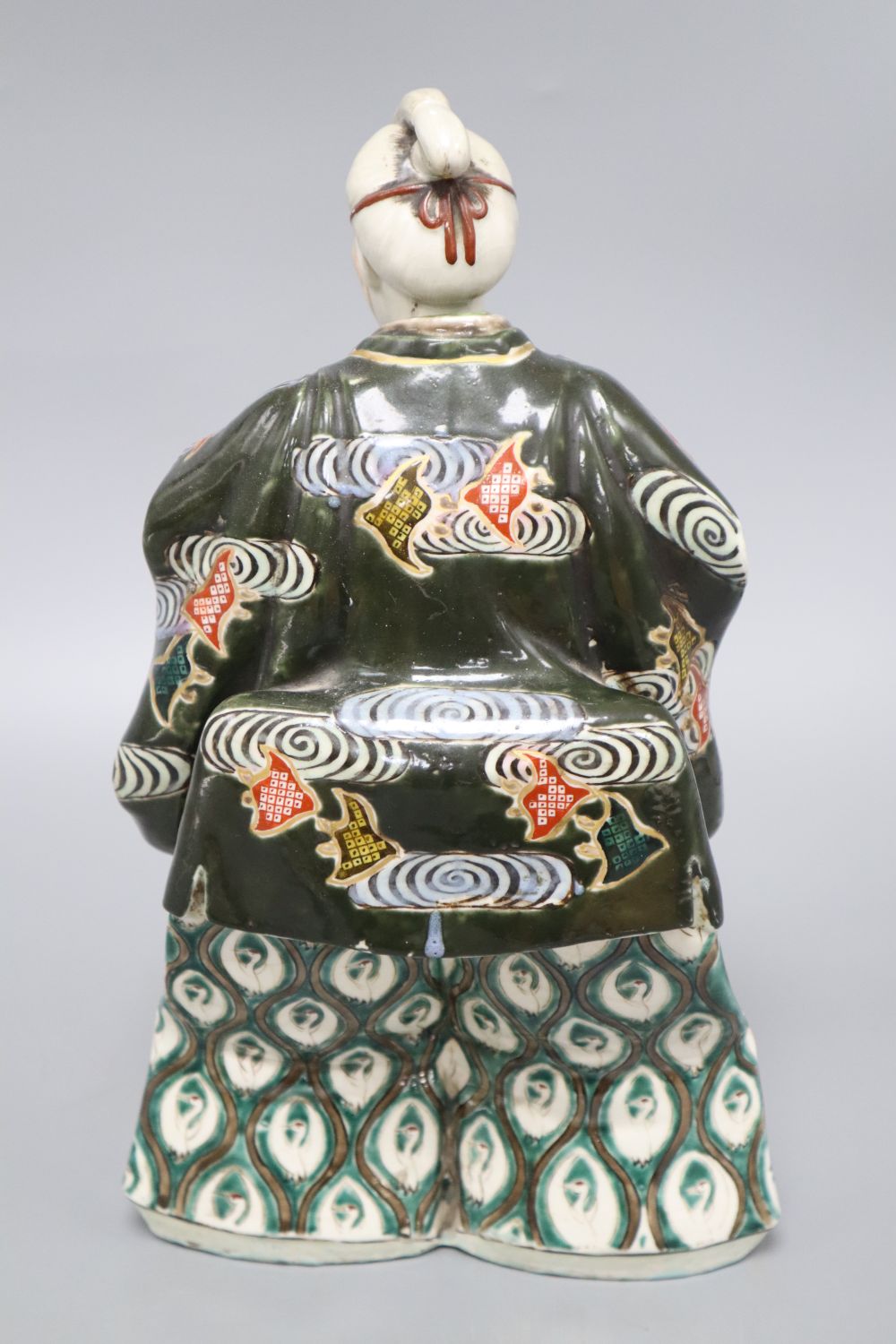 A Japanese ceramic model of a Samurai and a Chinese enamelled ceramic figure of a Buddha, tallest 31.5cm